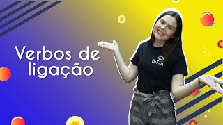 "Verbos de ligação" escrito sobre fundo colorido ao lado da imagem da professora