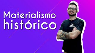"Materialismo histórico" escrito sobre fundo roxo ao lado da imagem do professor