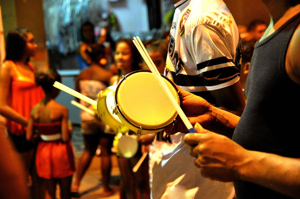 Homen tocando tamborim, um dos instrumentos que fazem parte da composição do samba.