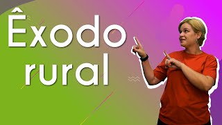 "Êxodo rural" escrito sobre fundo colorido ao lado da imagem da professora