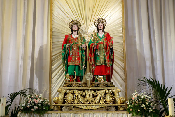 Imagem religiosa de São Cosme em Damião exposta em altar de igreja.